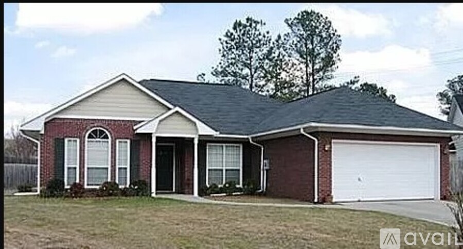 A house with a red brick exterior and a white garage door.