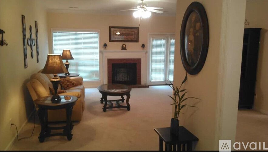 A living room with a fireplace and a painting on the wall.