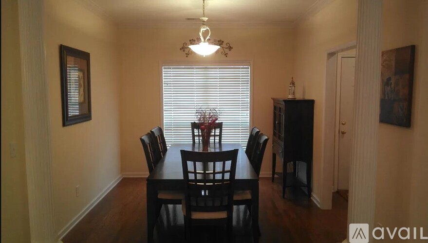 A dining room with a table set for six.