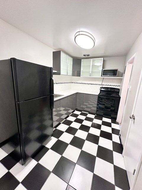 A black and white checkered floor in a kitchen.
