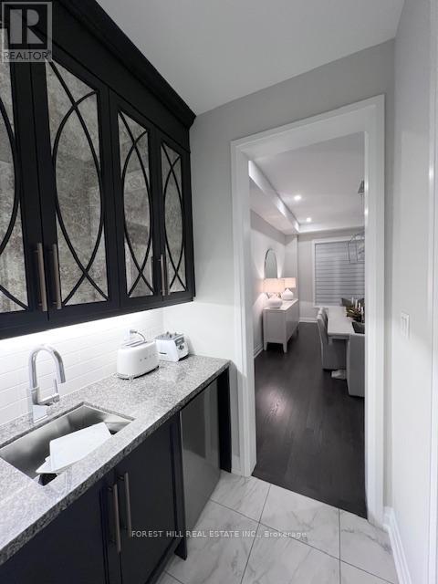 A kitchen with a sink and a toaster on the counter.