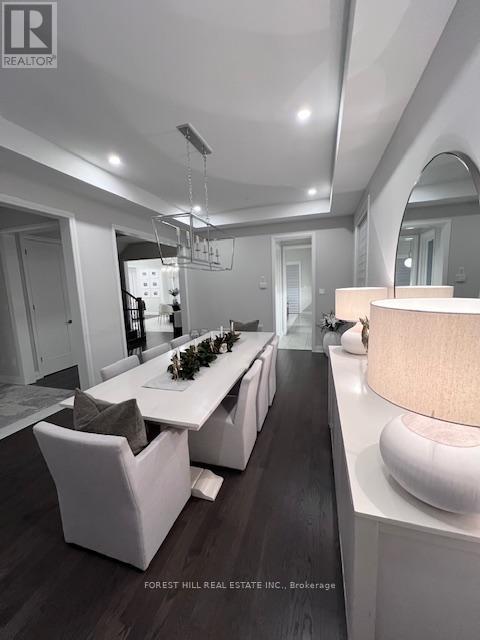 A modern dining room with a long table and chairs.