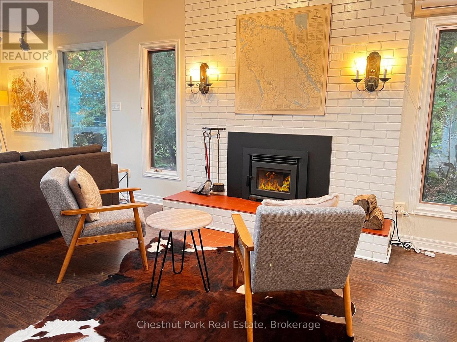 A living room with a fireplace and a painting on the wall.