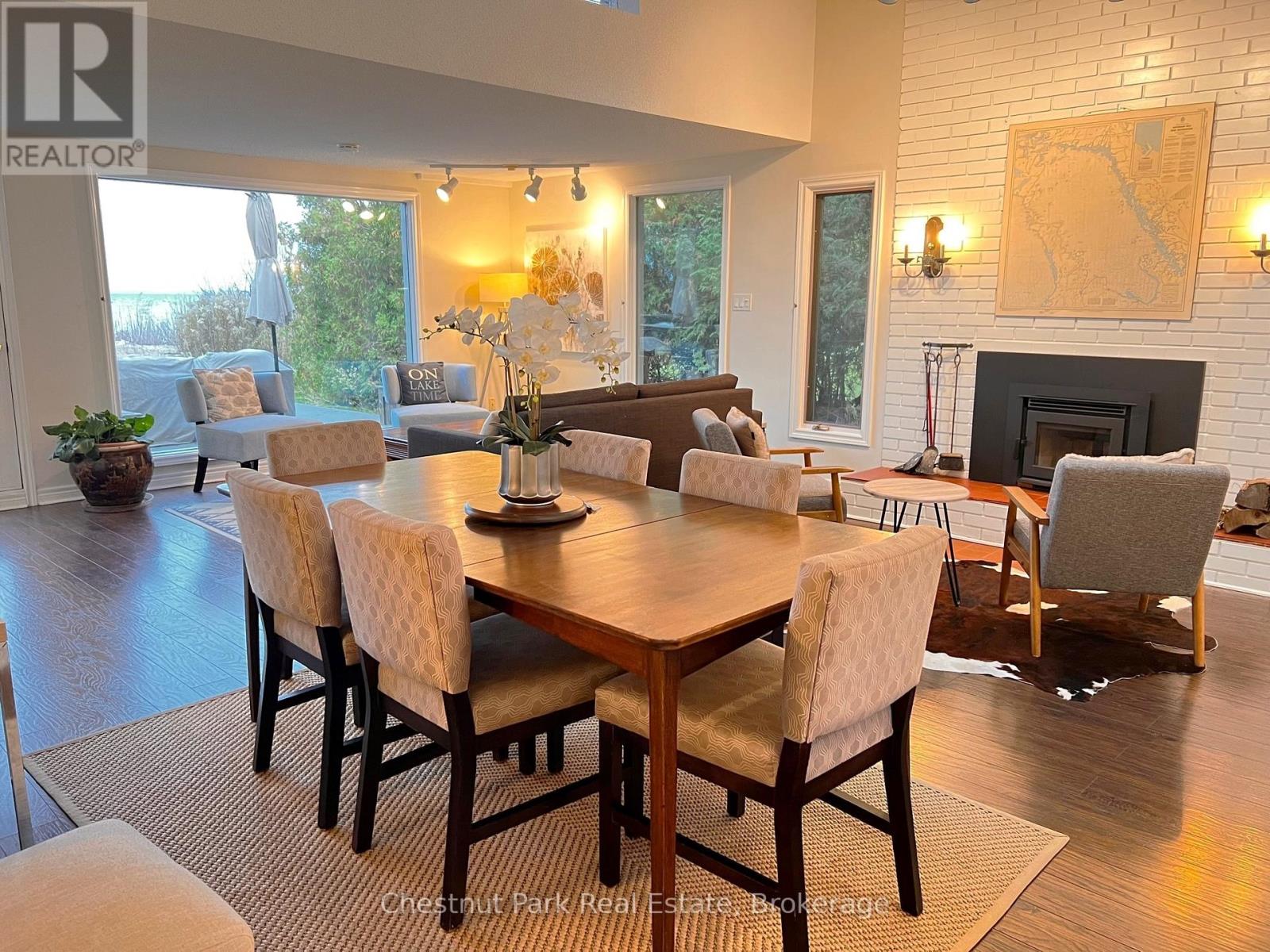 A dining room with a wooden table and chairs.