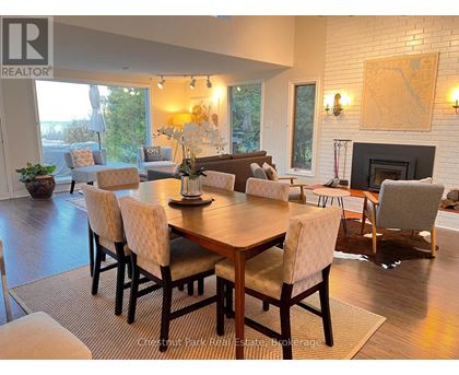 A dining room with a wooden table and chairs.