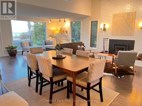 A dining room with a wooden table and chairs.