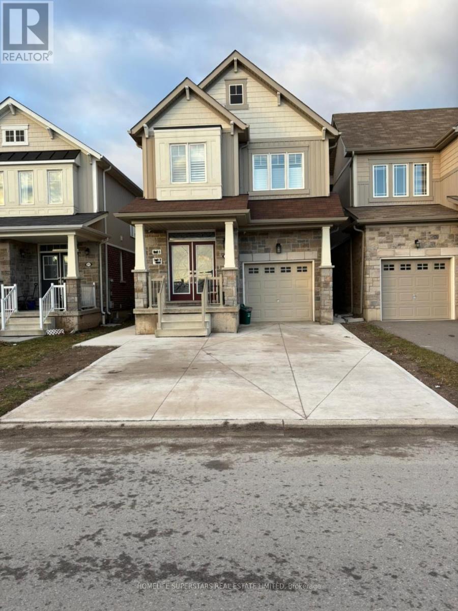 A real estate photo of a house with a driveway in front.