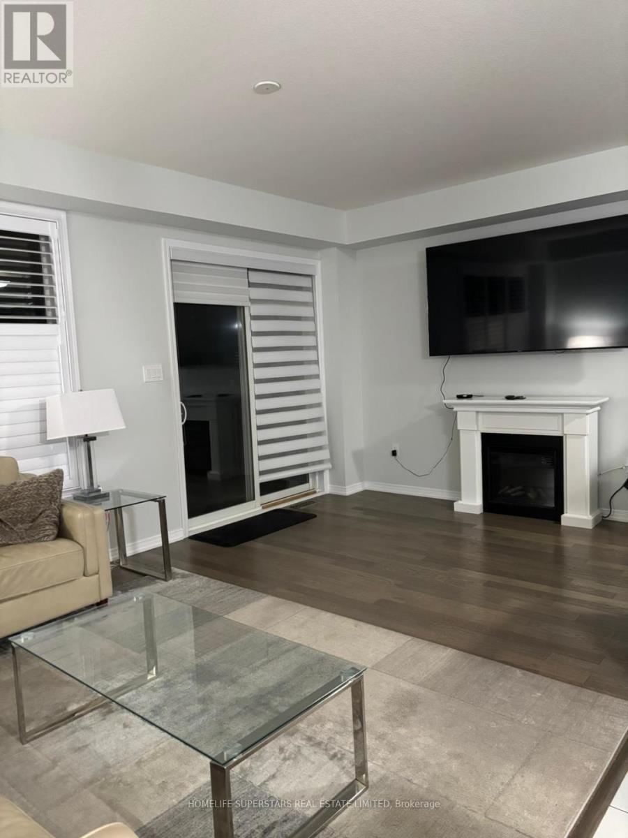 A living room with a glass coffee table and a fireplace.