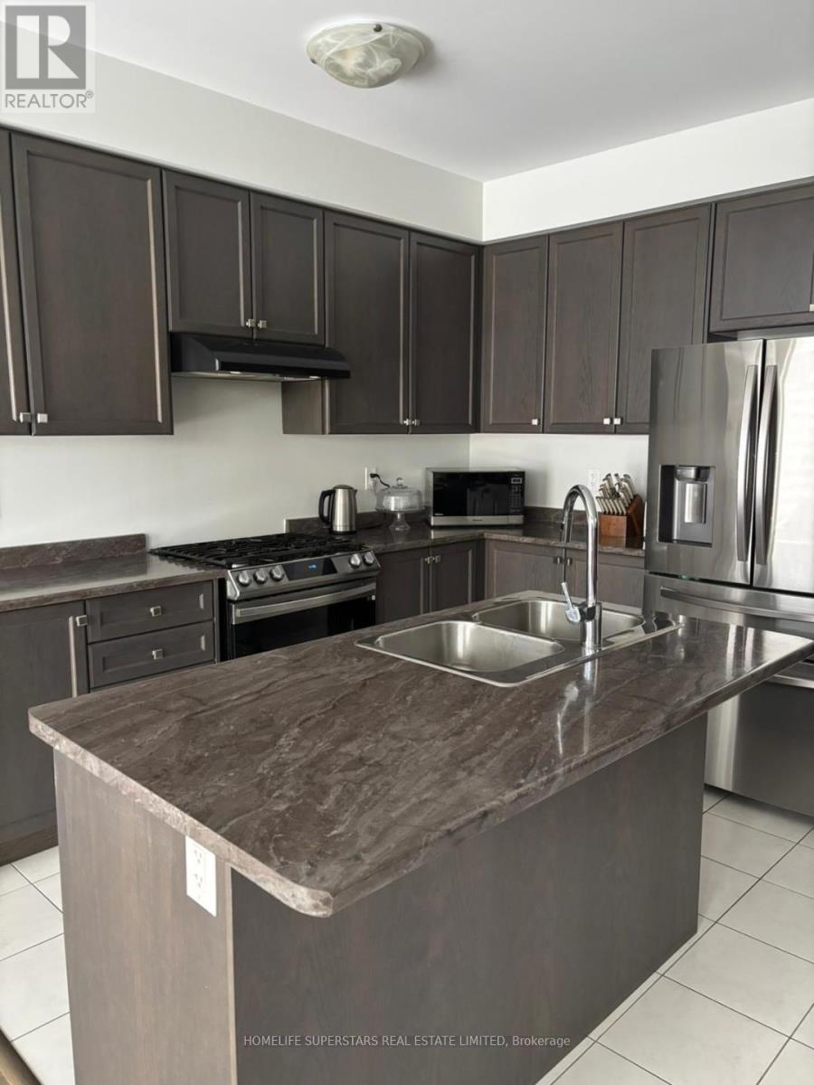 A kitchen with a brown counter top and stainless steel appliances.
