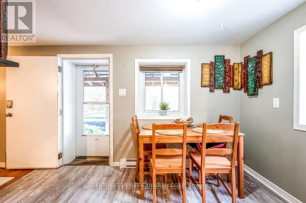 A dining room with a wooden table and chairs.