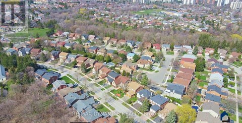 A bird's eye view of a residential area with houses and trees.