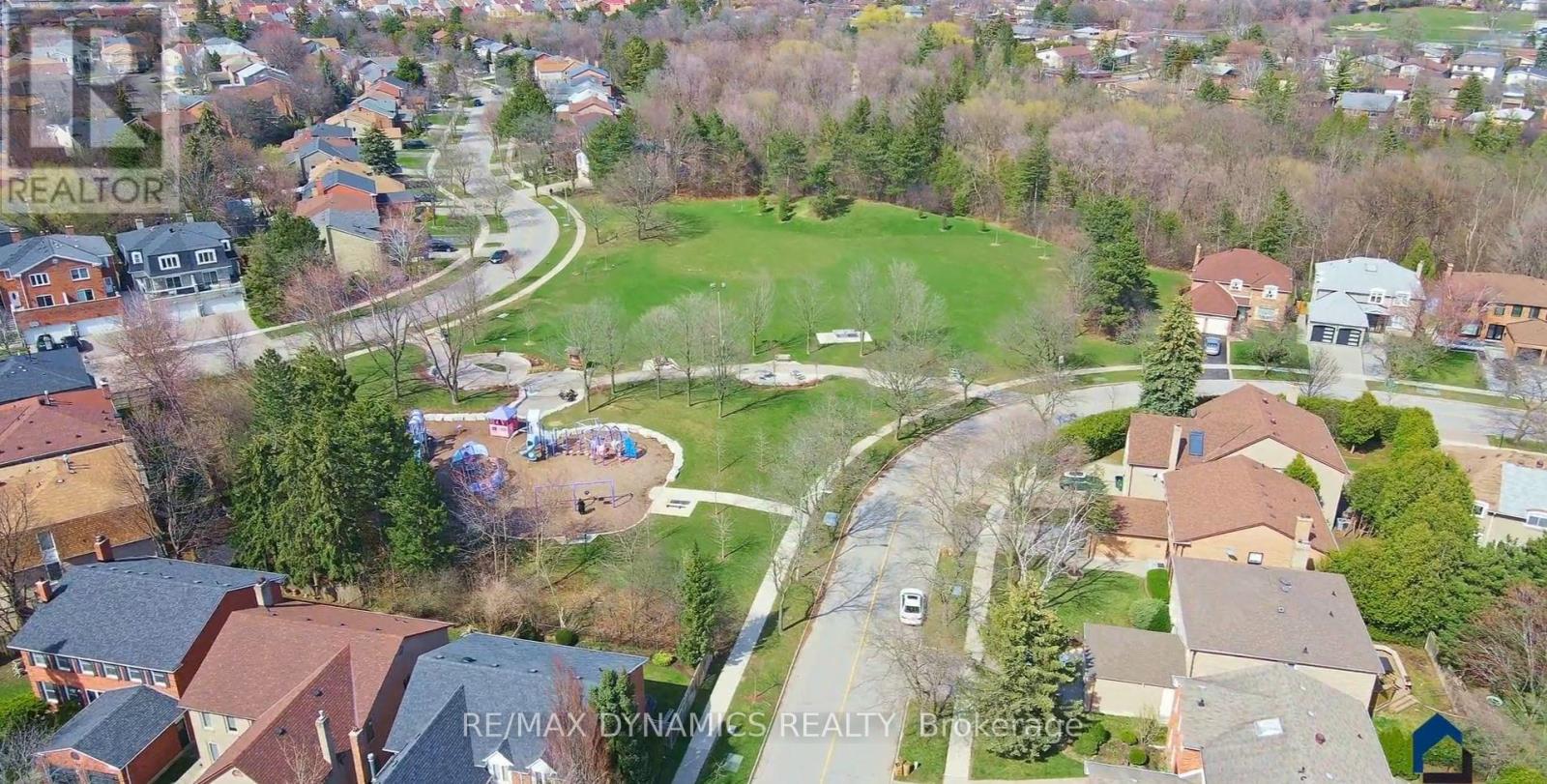 A bird's eye view of a residential neighborhood with houses and a park.