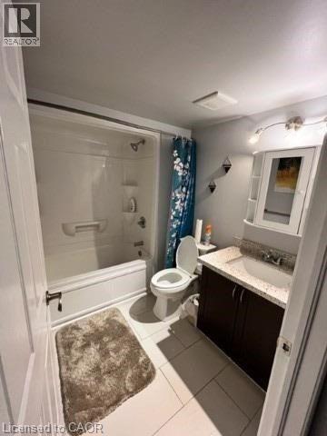 A bathroom with a toilet, sink, and shower.
