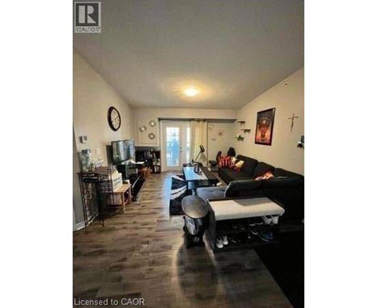 A living room with a couch, a chair, and a coffee table.