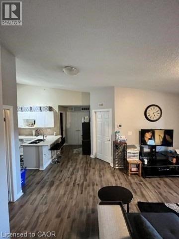 A living room with a couch, a chair, and a television.