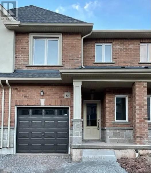 A brick house with a black garage door and a white door and windows.