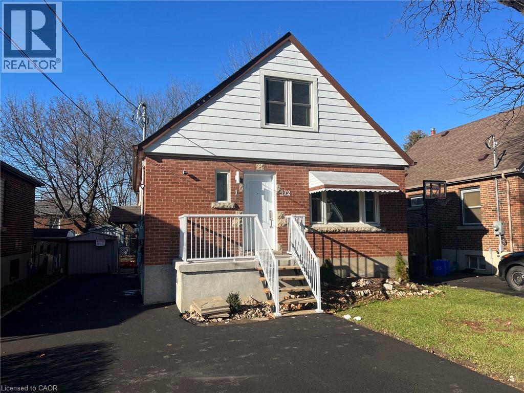 A house with a grey roof and a white door is for sale.