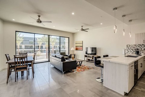 A modern kitchen with a dining table and chairs.