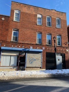 A red brick building with a closed garage door.