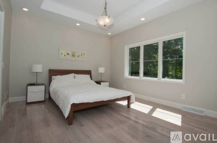 A bedroom with a large bed and a window.