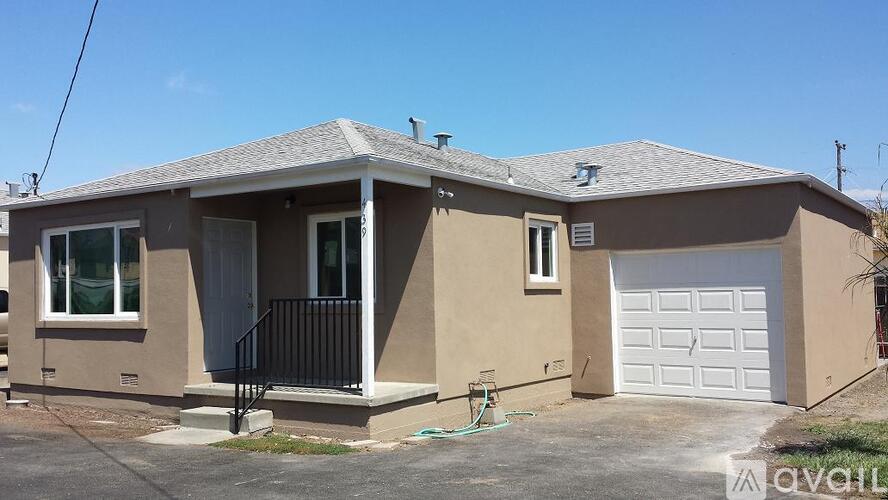 A house with a garage is for sale.