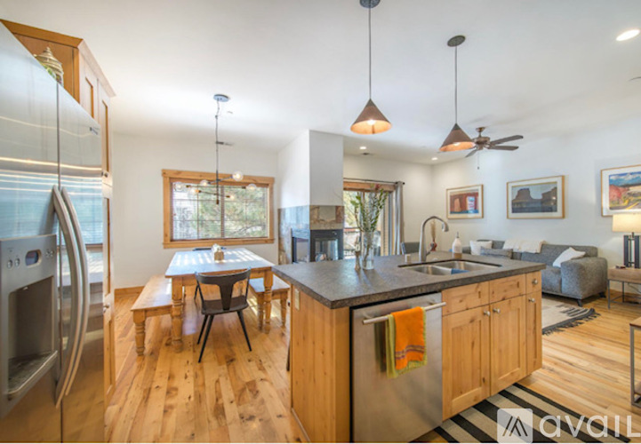 A modern kitchen with wooden cabinets and a large island.