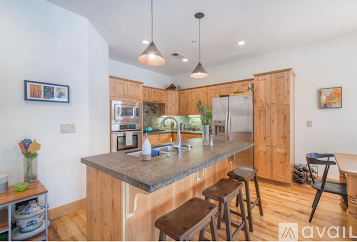 A kitchen with wooden cabinets and a granite countertop.