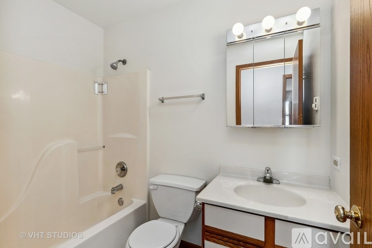 A white toilet sits next to a sink in a small bathroom.
