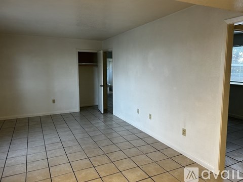 Empty room with tiled floor and white walls.