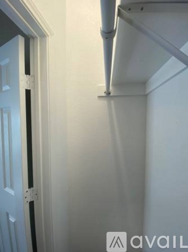 A white door is on the left and a white wall is on the right.