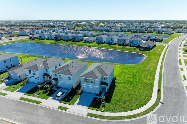 A bird's eye view of a residential area with houses and a swimming pool.