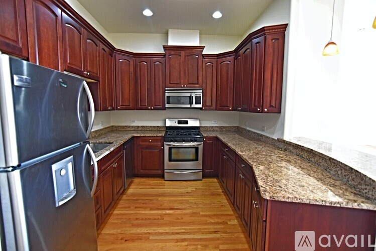 A spacious room with wooden floors and a ceiling fan.