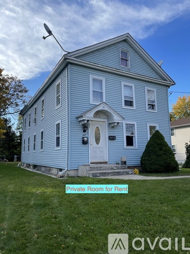 A blue house with a sign that says "Private Room for Rent".