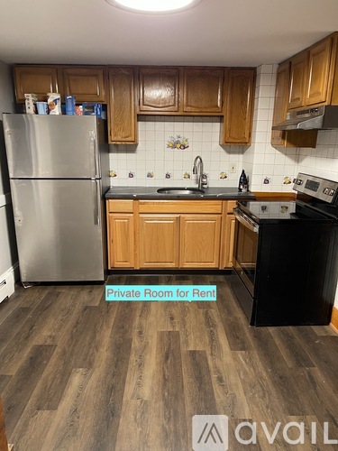 A kitchen with wooden cabinets and a refrigerator.