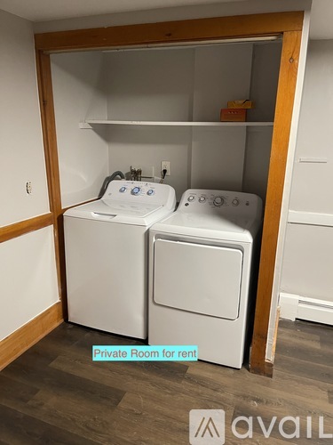 A small laundry room with a washer and dryer.