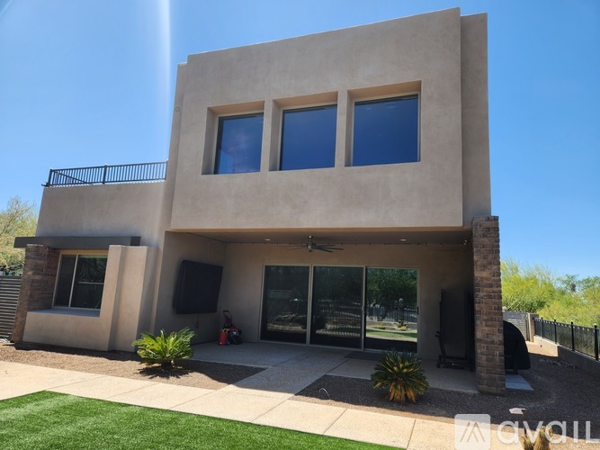 A modern house with a garage and a glass door entrance.