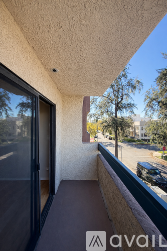 A balcony with a view of a street and cars.