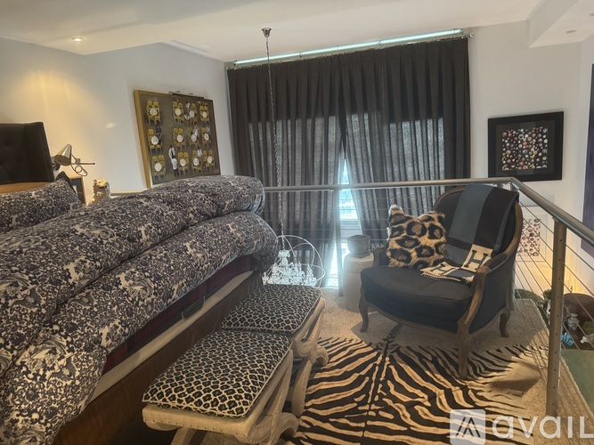 A living room with a grey sofa and a zebra print rug.