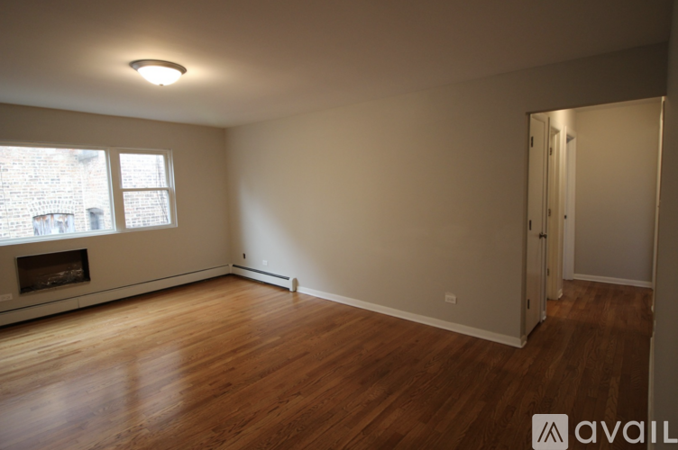 A room with a fireplace and a window.
