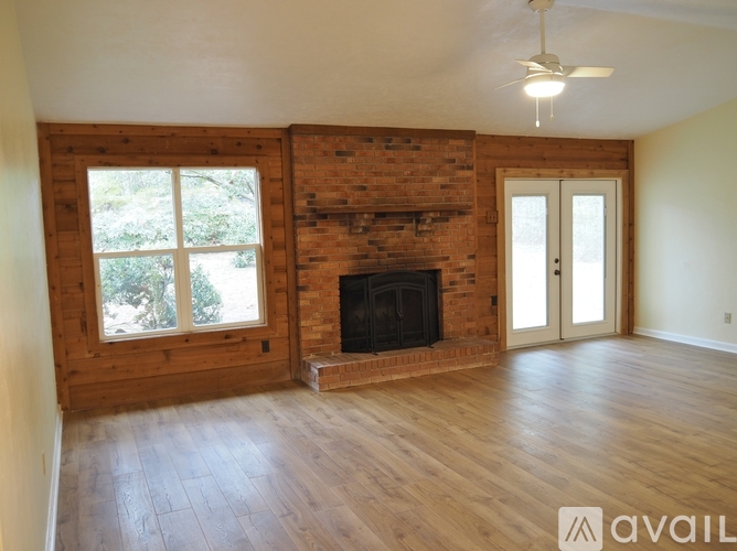 A room with a fireplace and wooden walls.