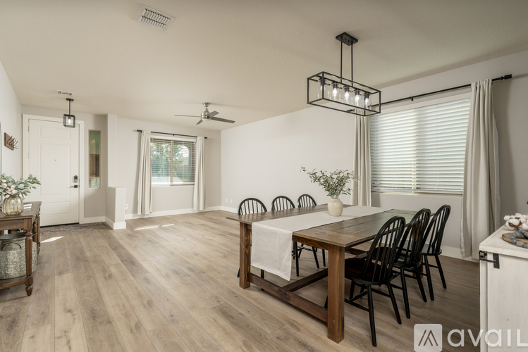 A dining room with a wooden table and chairs.