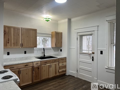 A kitchen with wooden cabinets and a white countertop.