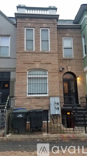 A brick building with a sign that says "available" in front of it.