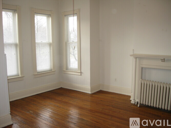 A room with wood floors and a fireplace.