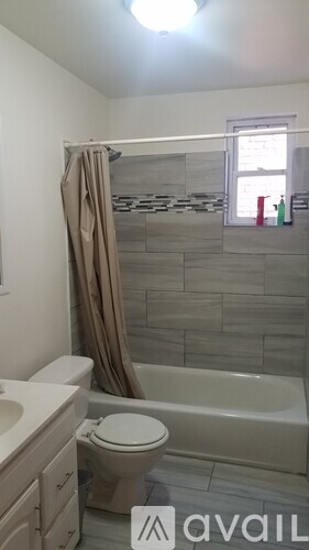 A bathroom with a toilet, sink, and bathtub.