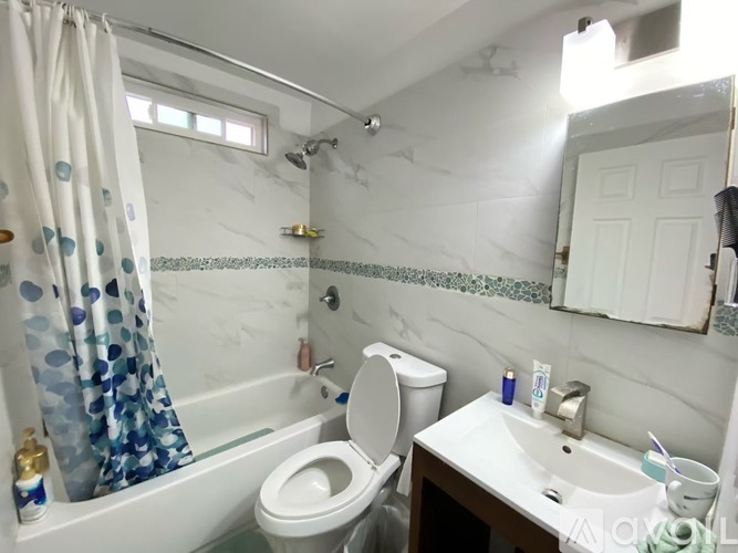 A white toilet sits next to a sink in a bathroom.