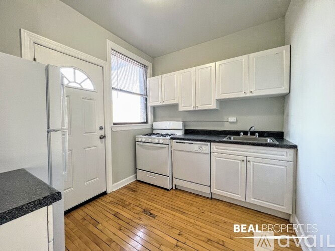 A kitchen with white appliances and cabinets.
