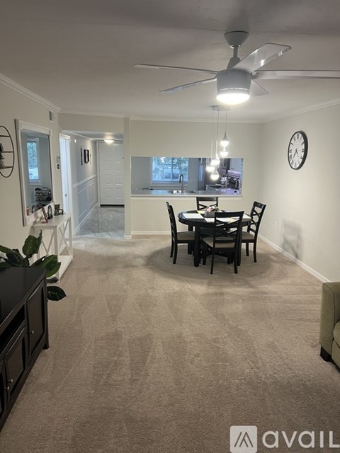 A living room with a dining table and chairs.