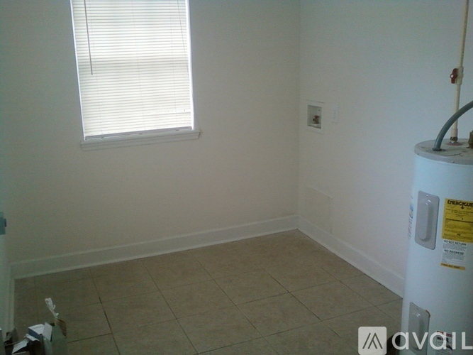 A room with a window and a tiled floor.