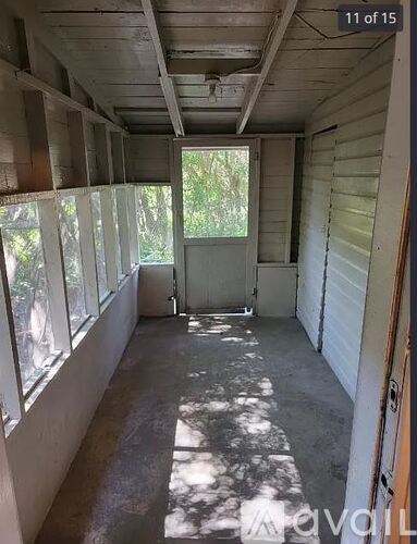 A room with a lot of windows and a door.